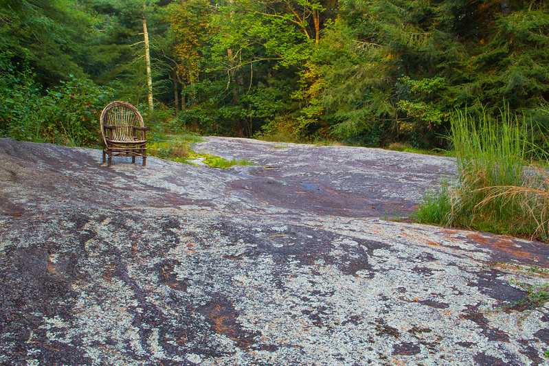 Sandburg's wicker chair on a rock outcrop behind their North Carolina home.